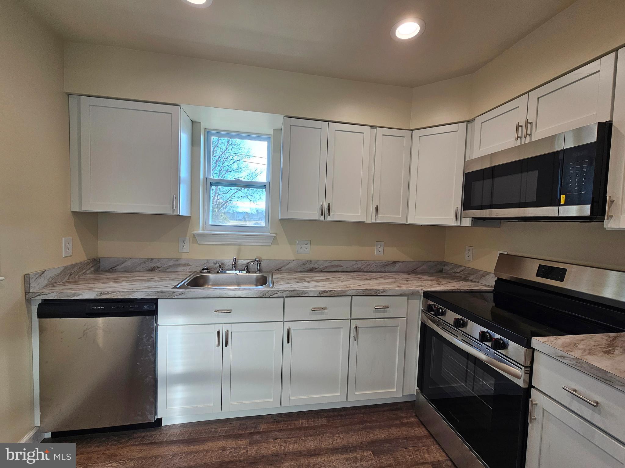 26404 Franklin Road Crisfield, MD 21817 - Photo 6 of 31 a kitchen with a sink stove and microwave