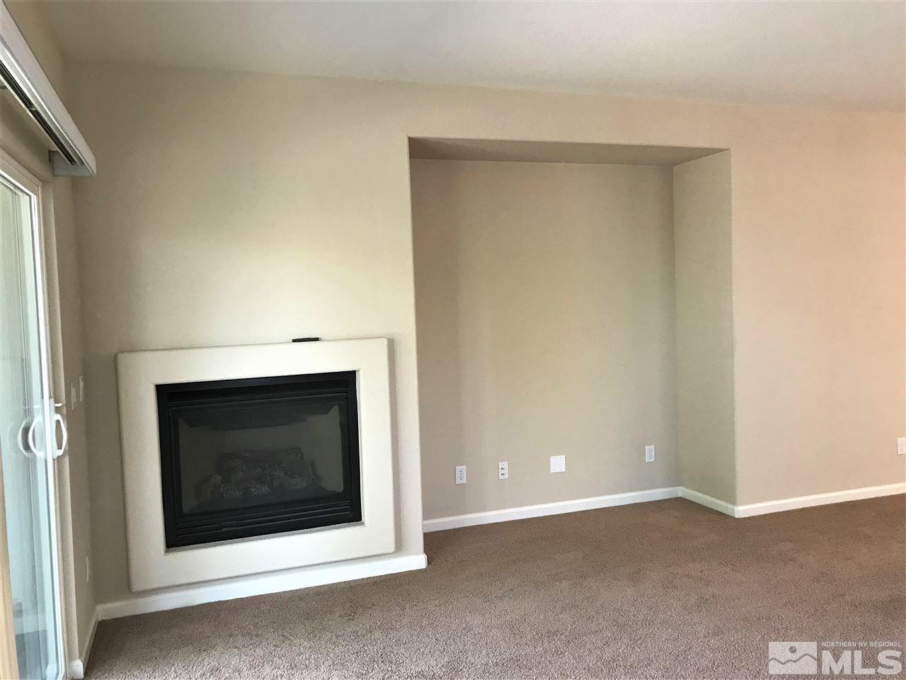 565 Little Sorrel Court Reno, NV 89521 - Photo 8 of 25 a fireplace with a hallway