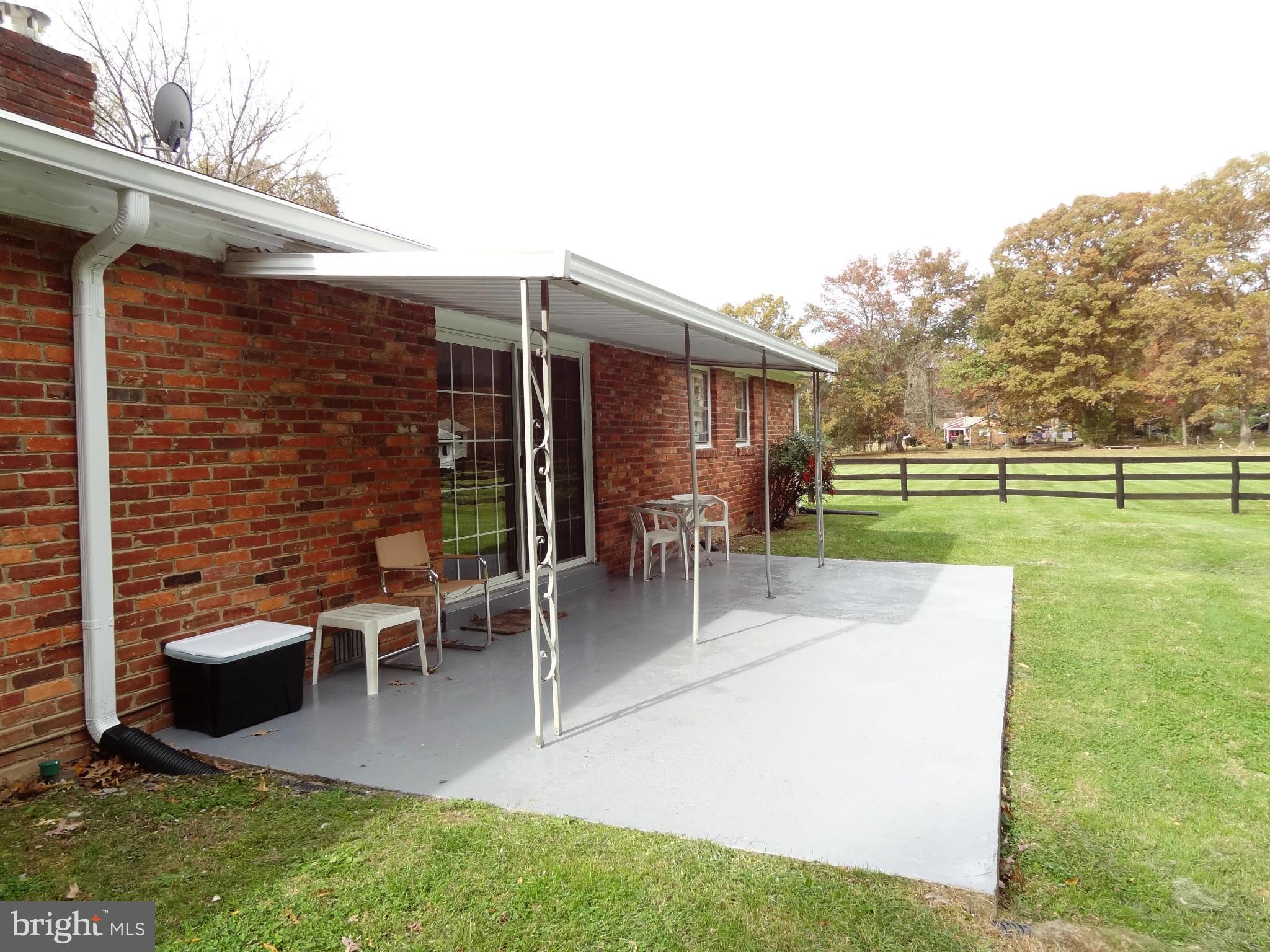 4878 Dumfries Road Catlett, VA 20119 - Photo 13 of 30 a view of a patio with table and chairs and potted plants