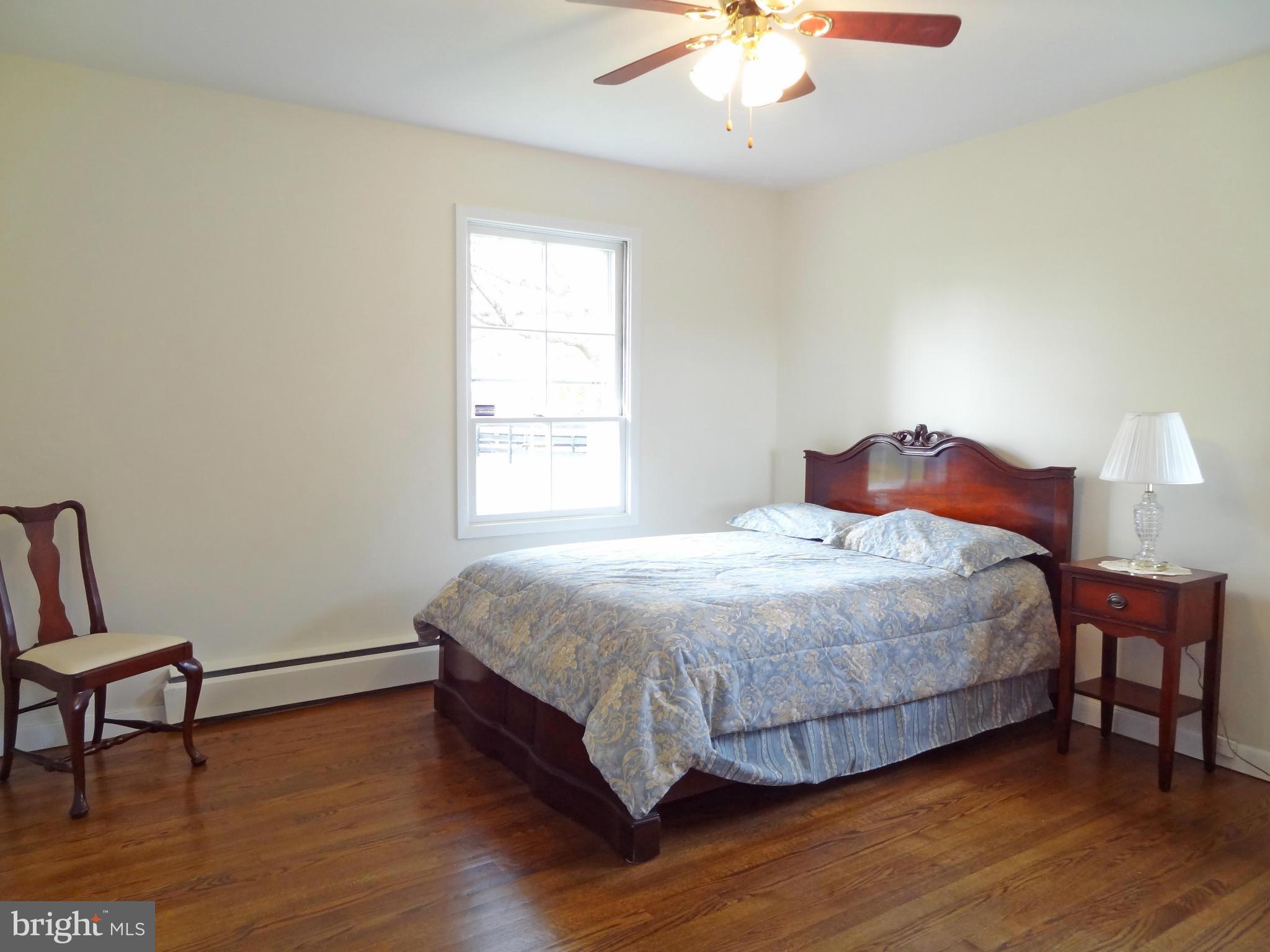 4878 Dumfries Road Catlett, VA 20119 - Photo 19 of 30 a bedroom with a bed a chair and a window