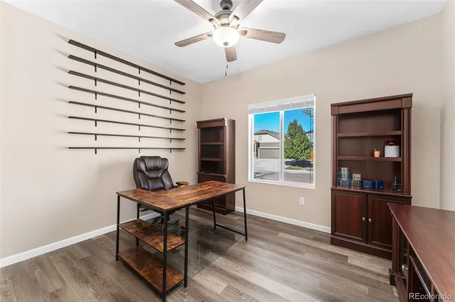 a view of a workspace with furniture and a window