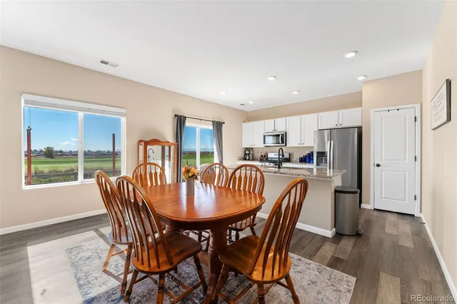 a dining room with furniture and window