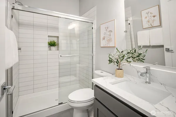 a bathroom with a sink toilet and shower