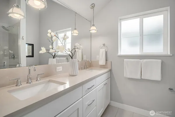 a bathroom with a double vanity sink and a mirror