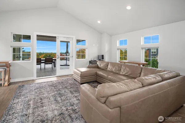 a living room with furniture and a dining table with kitchen view