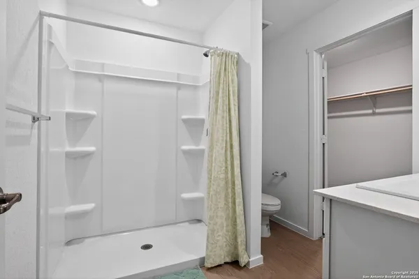 a bathroom with a shower and a glass door