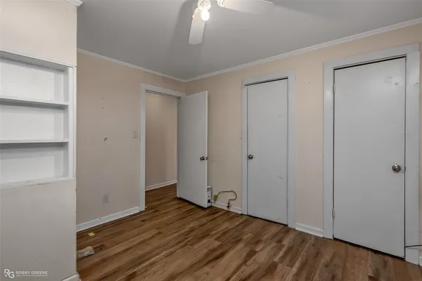 a view of an empty room with wooden floor