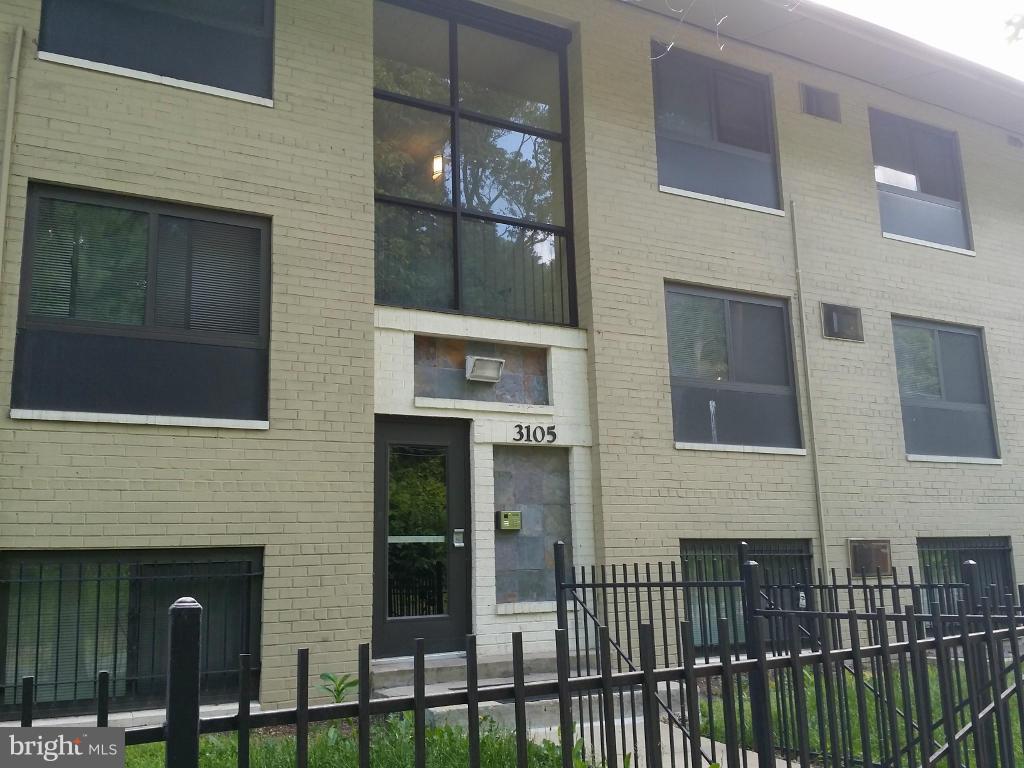 3105 Naylor Road Southeast, Unit 303 Washington, DC 20020 - Photo 1 of 10 a front view of a building with glass windows