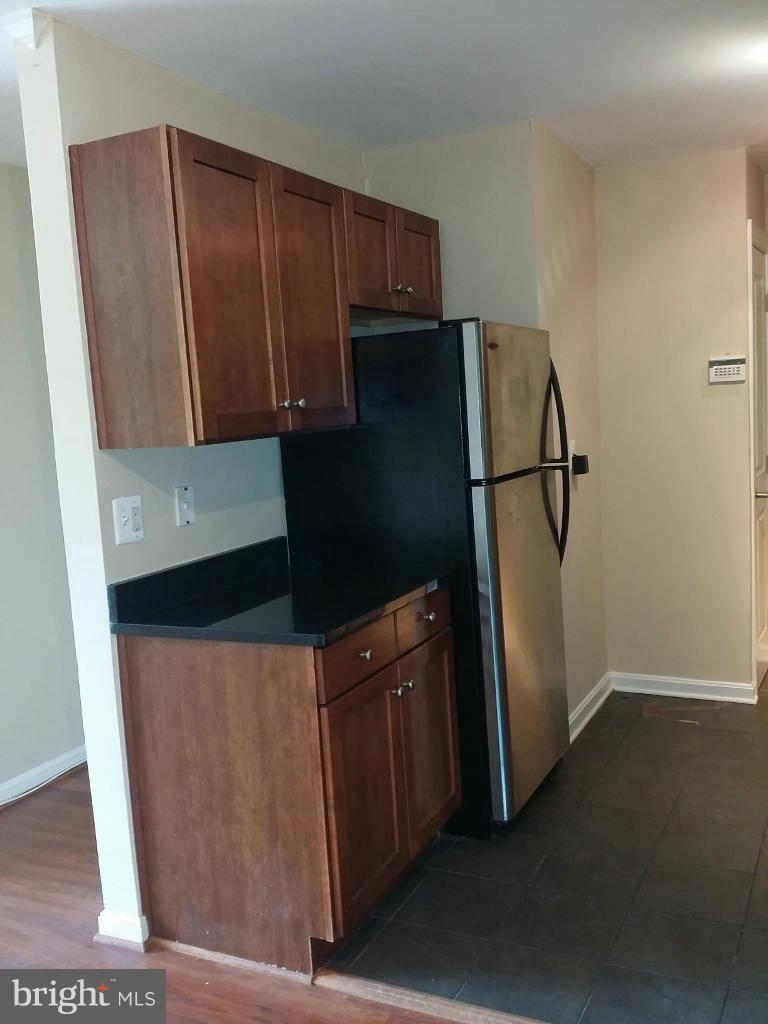 3105 Naylor Road Southeast, Unit 303 Washington, DC 20020 - Photo 6 of 10 a kitchen with a refrigerator and cabinets