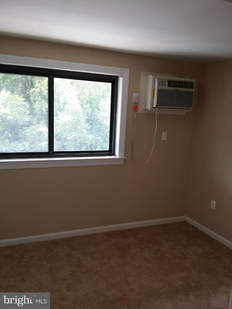 3105 Naylor Road Southeast, Unit 303 Washington, DC 20020 - Photo 8 of 10 an empty room with a window