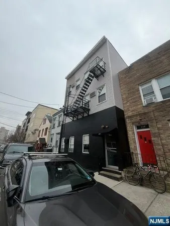 a view of a building with car parked