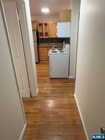 a kitchen with a stove sink and cabinets