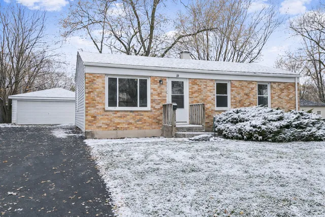 front view of a house with a large trees
