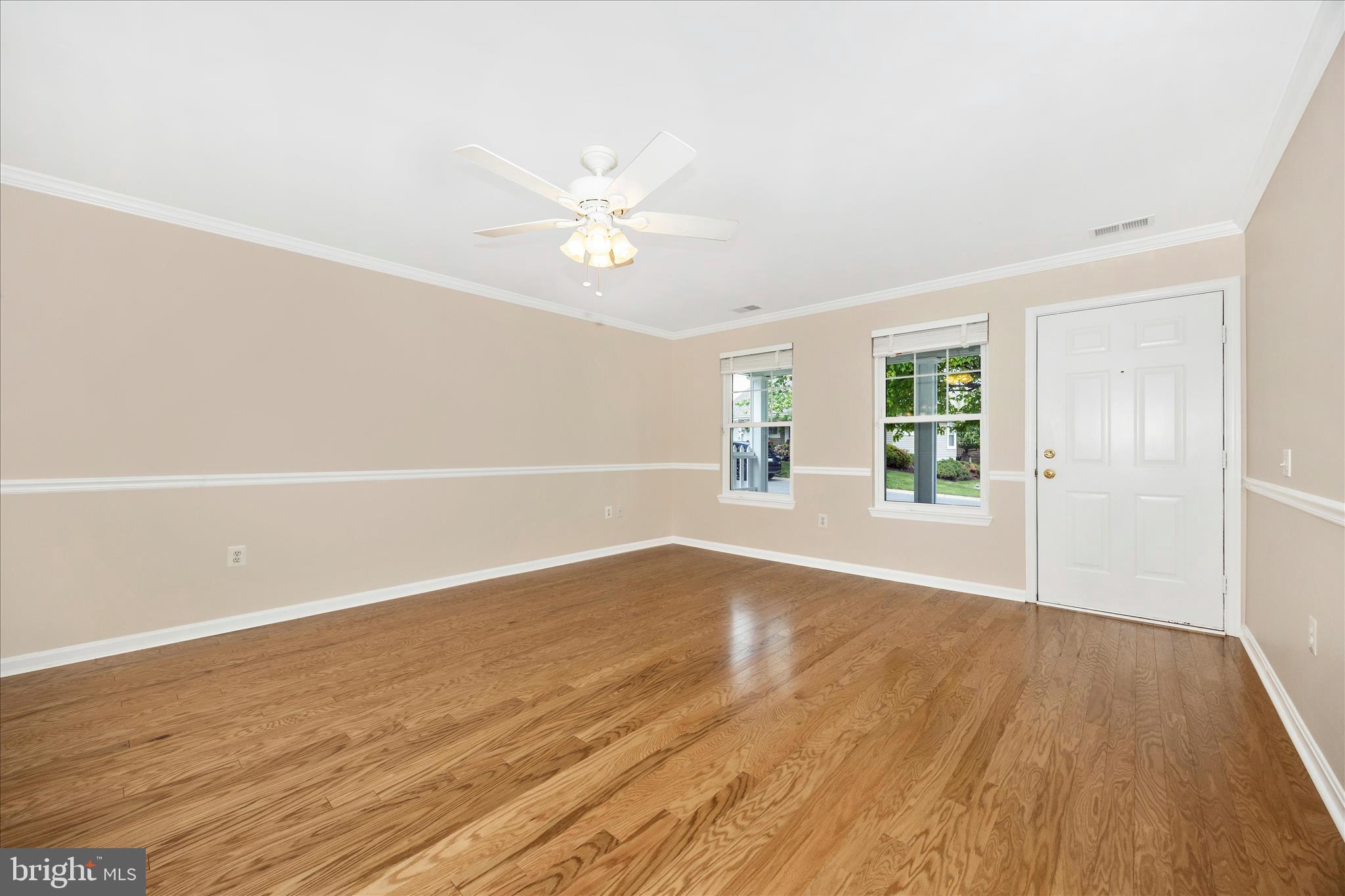 1007 Parade Lane Mount Airy, MD 21771 - Photo 11 of 55 an empty room with wooden floor and windows