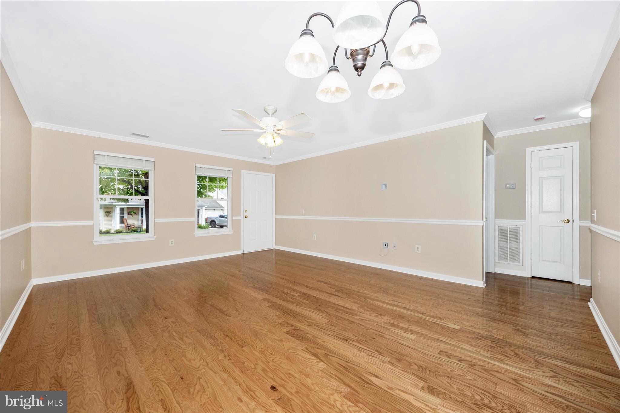 1007 Parade Lane Mount Airy, MD 21771 - Photo 16 of 55 an empty room with wooden floor cabinet and windows