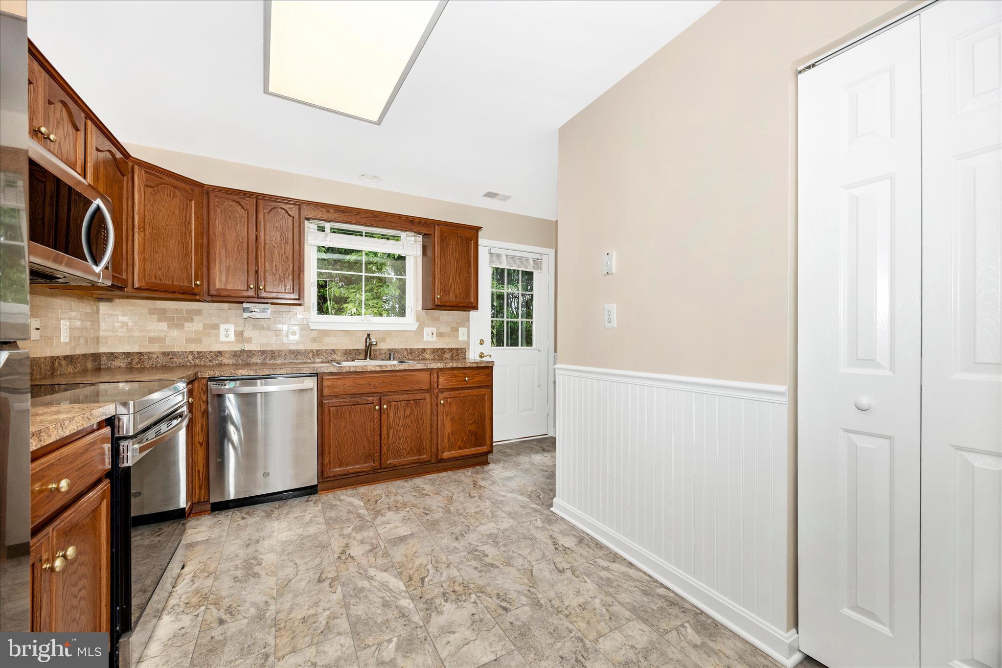 1007 Parade Lane Mount Airy, MD 21771 - Photo 17 of 55 a kitchen with stainless steel appliances granite countertop a stove a sink and a refrigerator