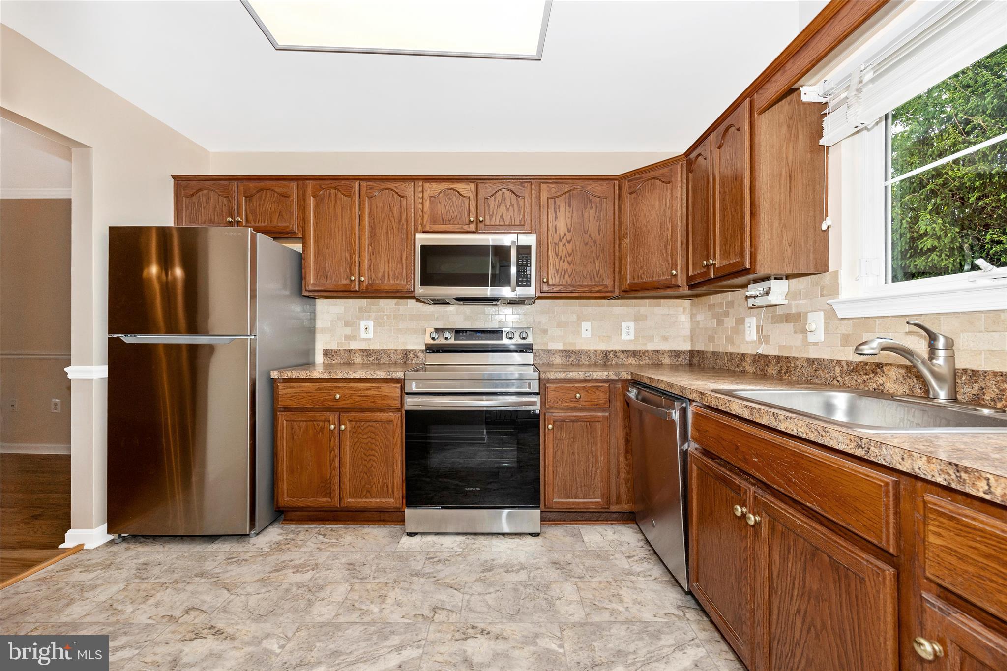 1007 Parade Lane Mount Airy, MD 21771 - Photo 20 of 55 a kitchen with stainless steel appliances granite countertop a refrigerator stove and sink