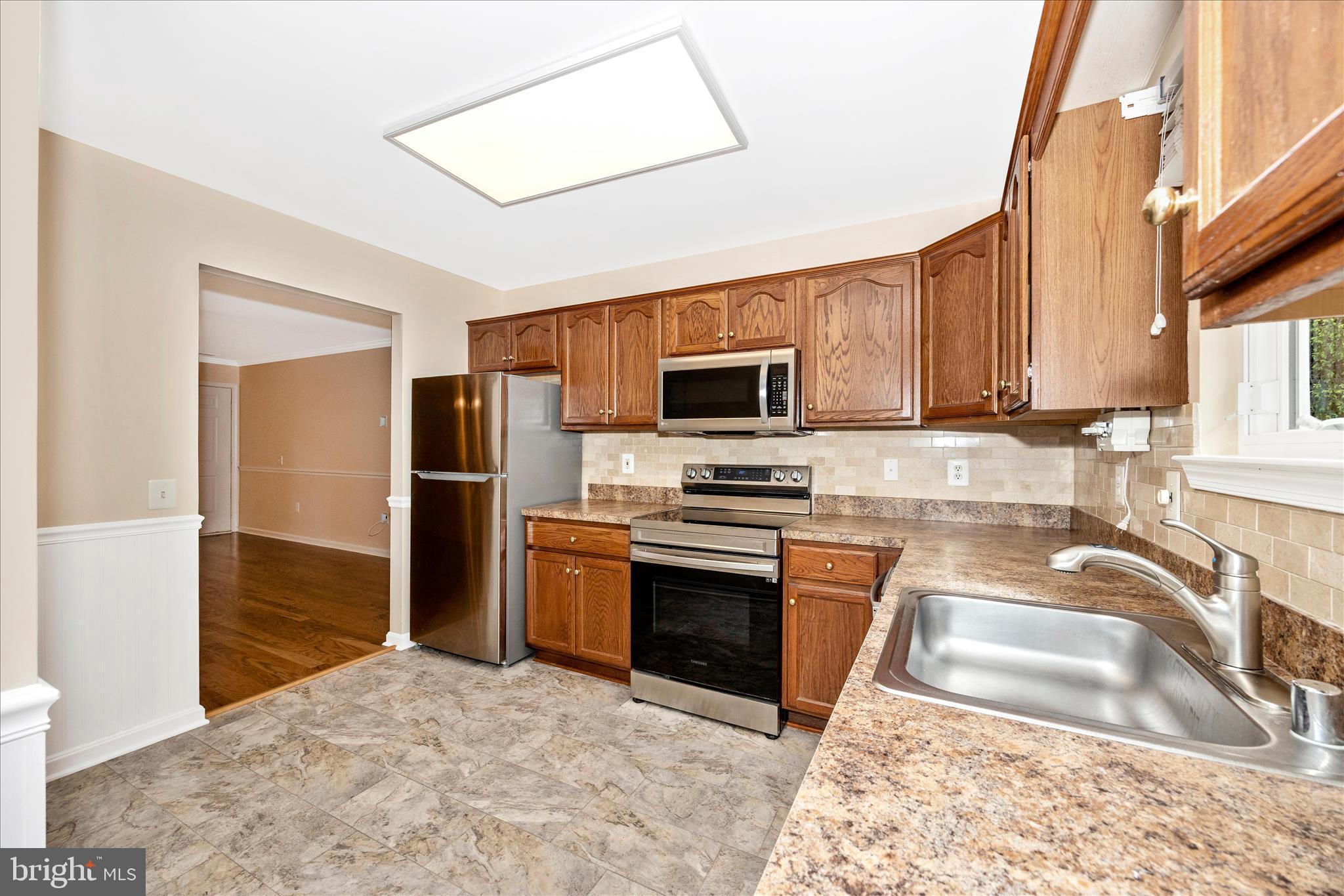 1007 Parade Lane Mount Airy, MD 21771 - Photo 21 of 55 a kitchen with granite countertop a refrigerator and a sink