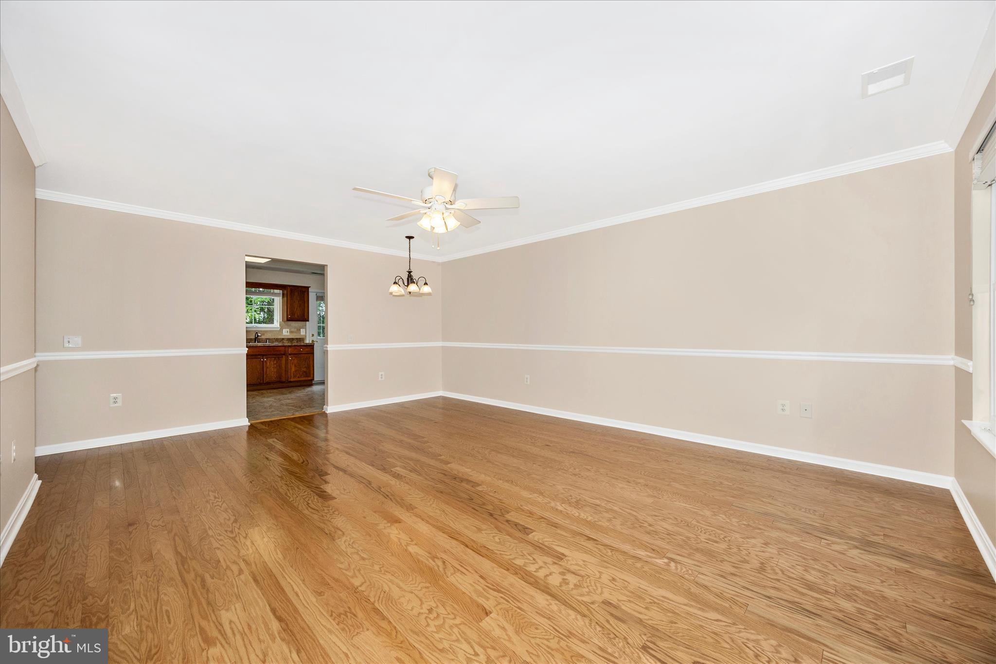 1007 Parade Lane Mount Airy, MD 21771 - Photo 7 of 55 a view of an empty room with wooden floor and a window
