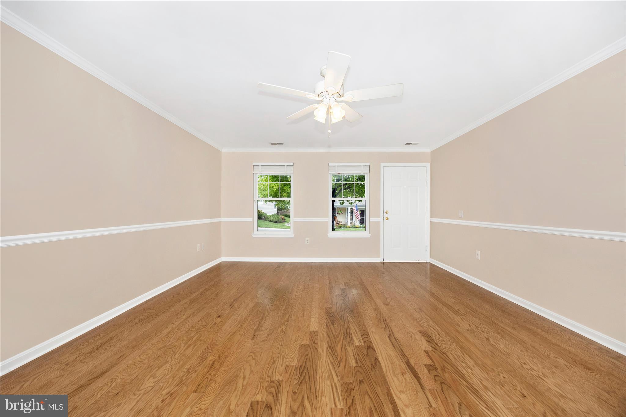 1007 Parade Lane Mount Airy, MD 21771 - Photo 10 of 55 an empty room with wooden floor fan and windows