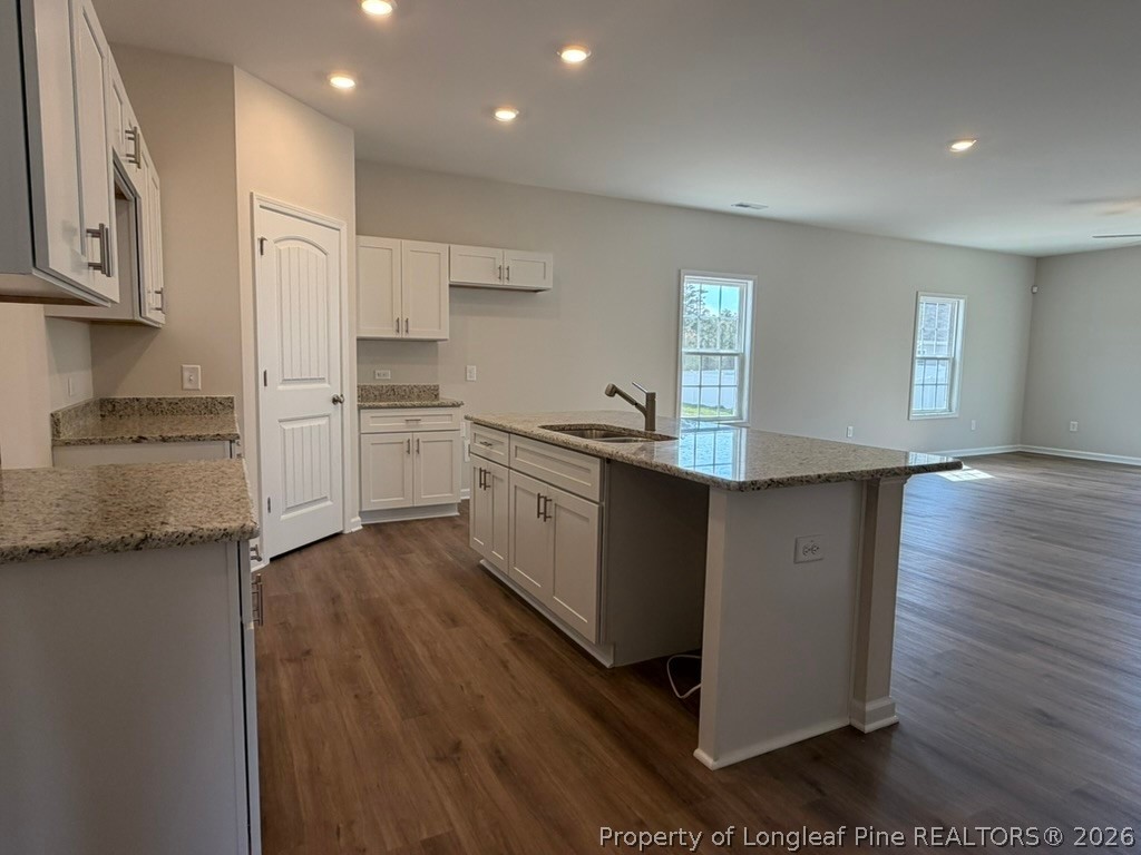5409 Short Leaf Road Fayetteville, NC 28311 - Photo 11 of 40 a kitchen with stainless steel appliances granite countertop a stove a sink and a refrigerator