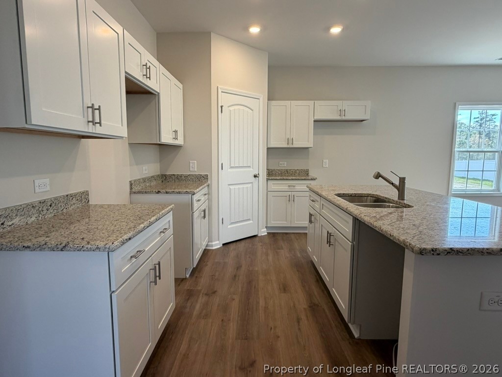 5409 Short Leaf Road Fayetteville, NC 28311 - Photo 12 of 40 a kitchen with stainless steel appliances granite countertop a sink stove microwave and cabinets