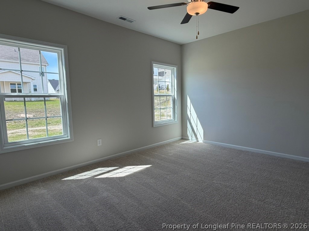 5409 Short Leaf Road Fayetteville, NC 28311 - Photo 23 of 40 en empty room with windows and chandelier fan
