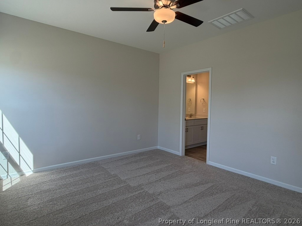 5409 Short Leaf Road Fayetteville, NC 28311 - Photo 24 of 40 an empty room with a chandelier fan and windows