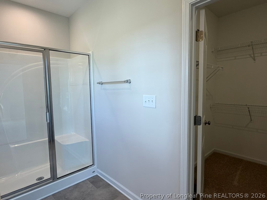 5409 Short Leaf Road Fayetteville, NC 28311 - Photo 28 of 40 a bathroom with a glass shower door