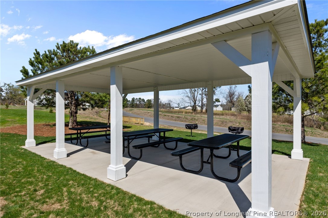 5409 Short Leaf Road Fayetteville, NC 28311 - Photo 39 of 40 a view of a patio with a table and chairs under an umbrella