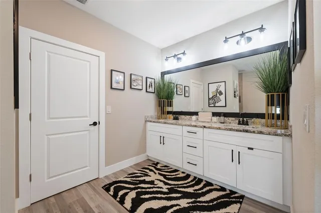 a bedroom with a sink and a mirror