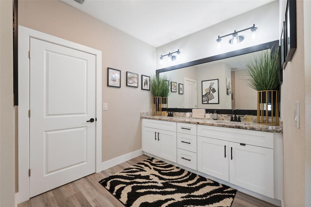 13073 Jaywalk Road Weeki Wachee, FL 34614 - Photo 11 of 44 a bedroom with a sink and a mirror