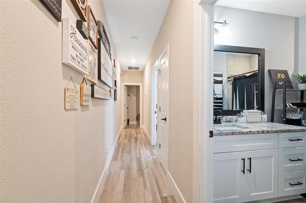 13073 Jaywalk Road Weeki Wachee, FL 34614 - Photo 13 of 44 a spacious bathroom with a granite countertop sink and a mirror