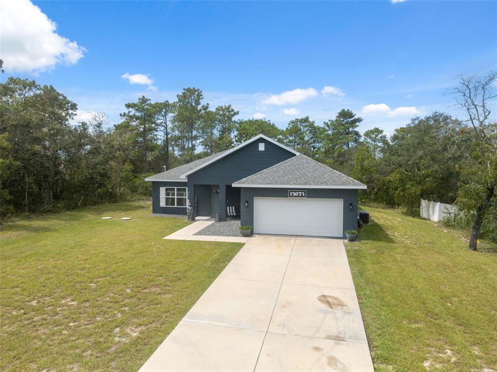 13073 Jaywalk Road Weeki Wachee, FL 34614 - Photo 19 of 44 a front view of house with yard and trees
