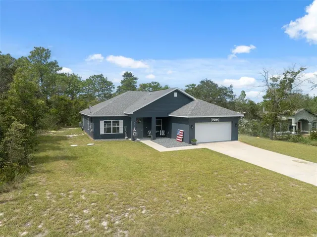 a front view of a house with yard and garage