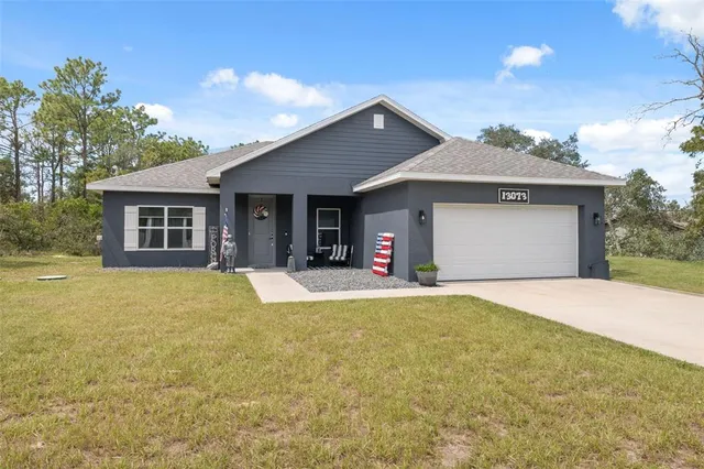 a kitchen with stainless steel appliances a dining table chairs and wooden floor