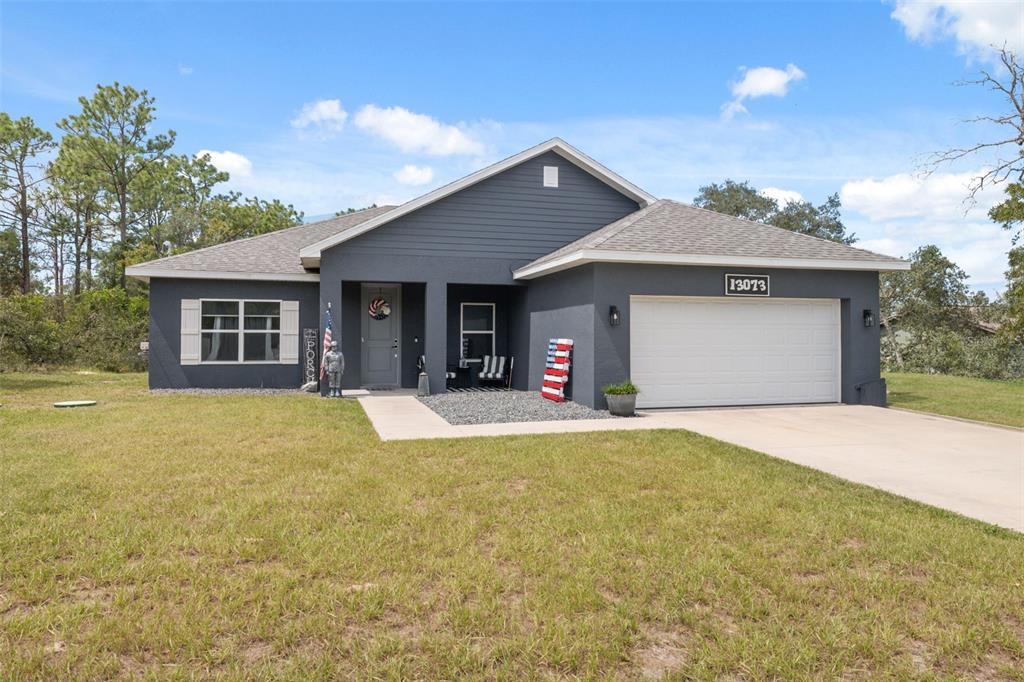 13073 Jaywalk Road Weeki Wachee, FL 34614 - Photo 33 of 44 a front view of a house with a yard and garage