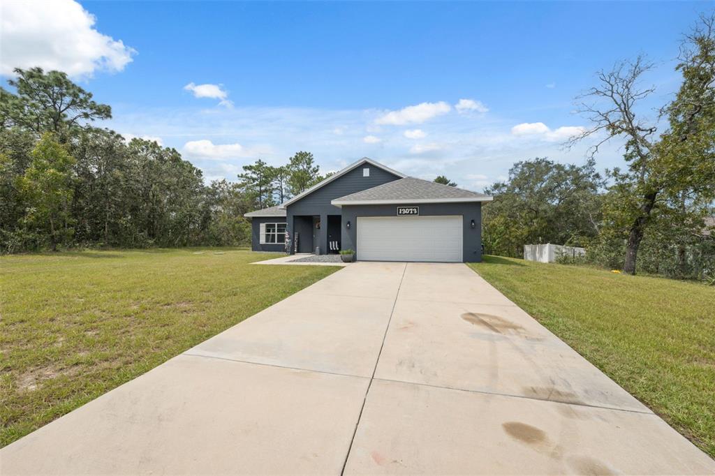13073 Jaywalk Road Weeki Wachee, FL 34614 - Photo 34 of 44 a front view of a house with a yard