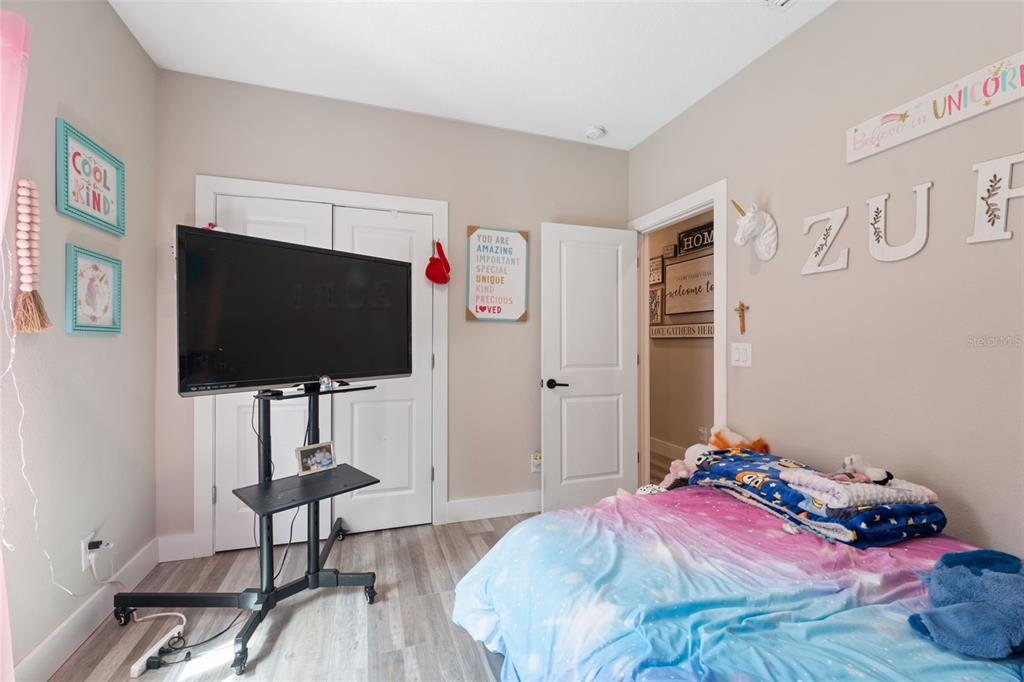 13073 Jaywalk Road Weeki Wachee, FL 34614 - Photo 44 of 44 a bedroom with a bed and a flat screen tv