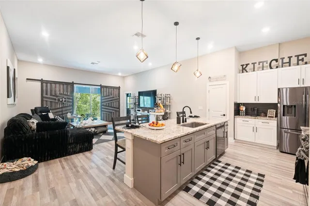 a kitchen with a sink stove and refrigerator