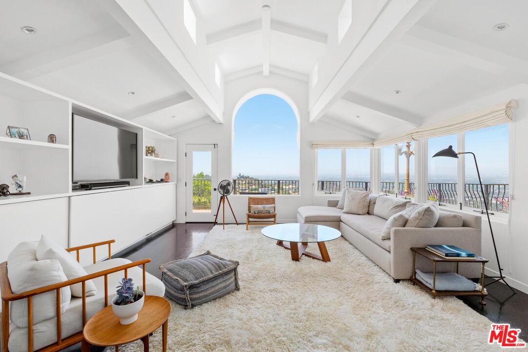 8663 Edwin Drive Los Angeles, CA 90046 - Photo 2 of 11 a living room with furniture and a flat screen tv