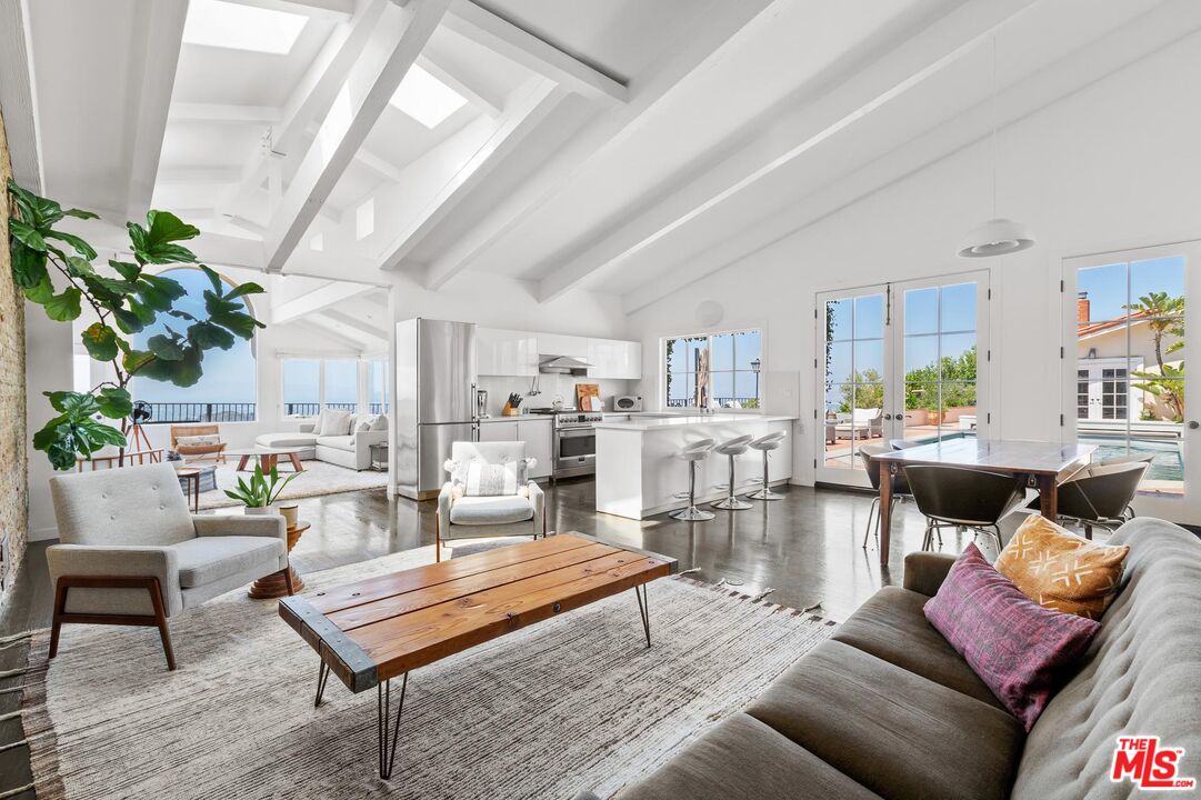 8663 Edwin Drive Los Angeles, CA 90046 - Photo 5 of 11 a living room with furniture a rug potted plant and a large window