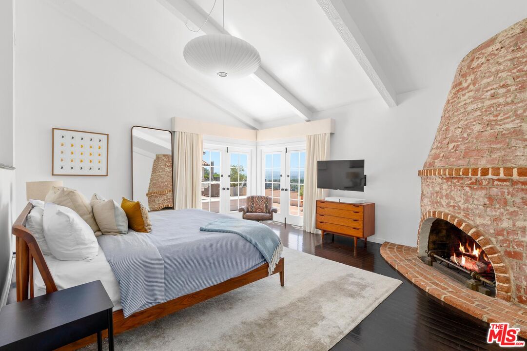 8663 Edwin Drive Los Angeles, CA 90046 - Photo 7 of 11 a bedroom with a bed and wooden floor