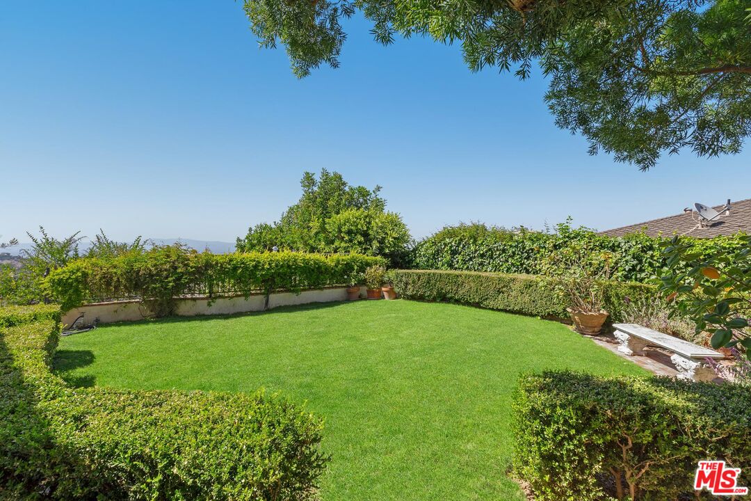 8663 Edwin Drive Los Angeles, CA 90046 - Photo 9 of 11 a view of a garden with a building in the background