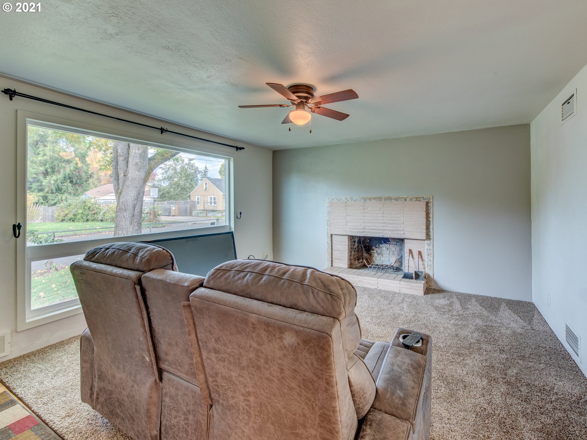 1393 8th Street Springfield, OR 97477 - Photo 6 of 23 a living room with furniture a fireplace and a large window
