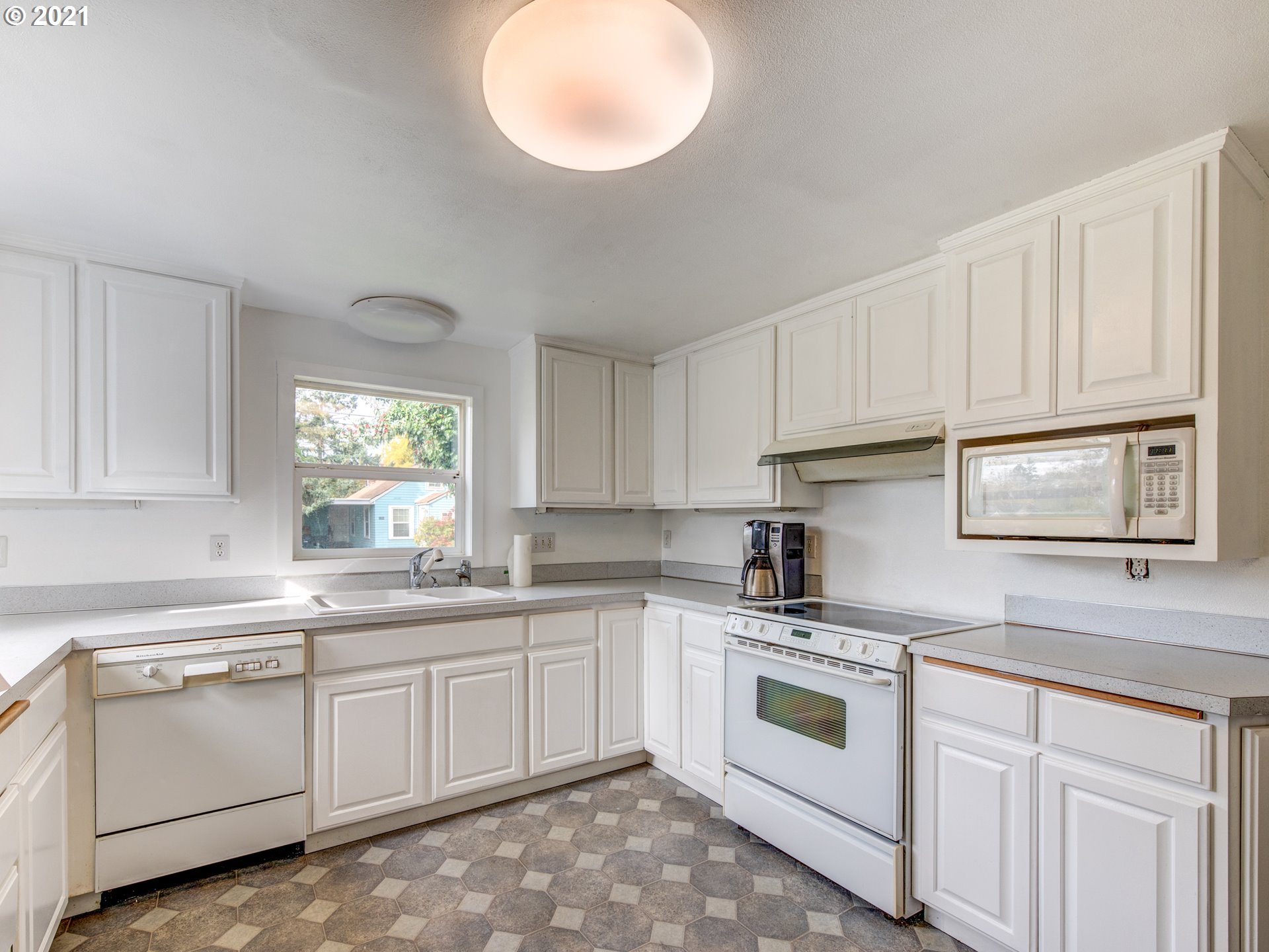 1393 8th Street Springfield, OR 97477 - Photo 8 of 23 a kitchen with white cabinets white stainless steel appliances and sink