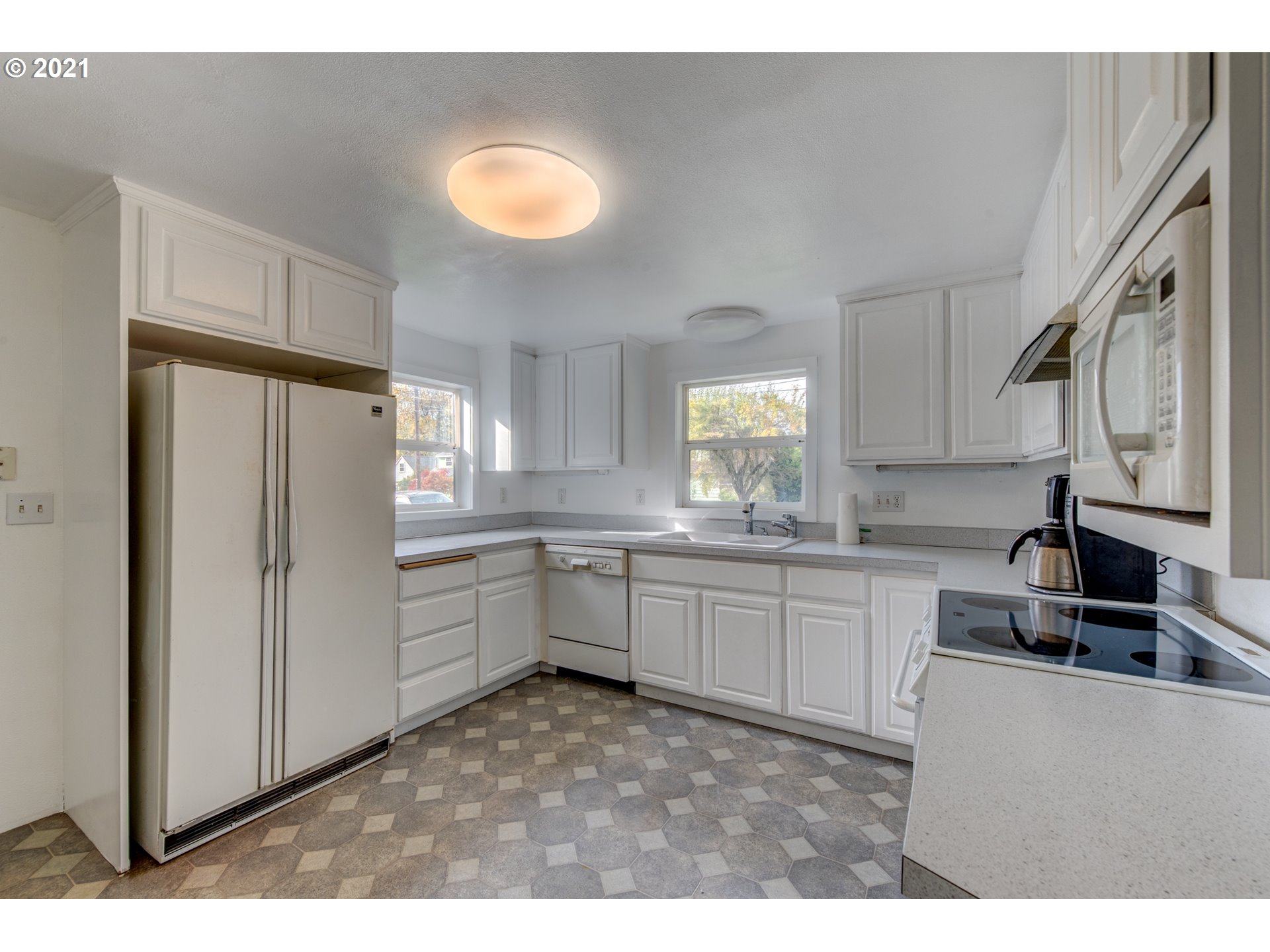 1393 8th Street Springfield, OR 97477 - Photo 10 of 23 a kitchen with granite countertop a refrigerator stove top oven and sink