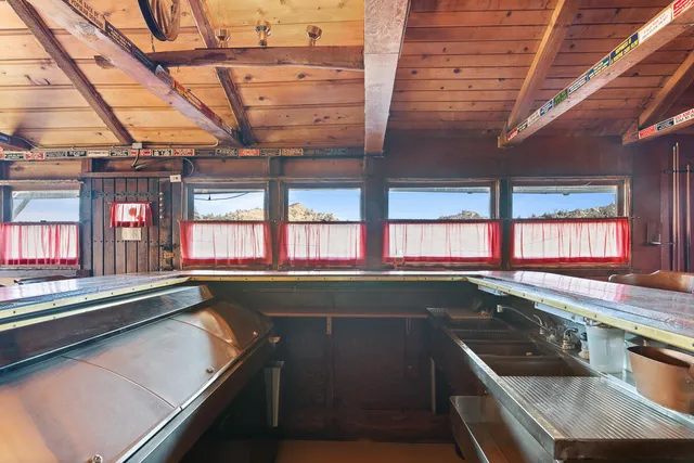 a kitchen that has a sink a stove and a wooden floors