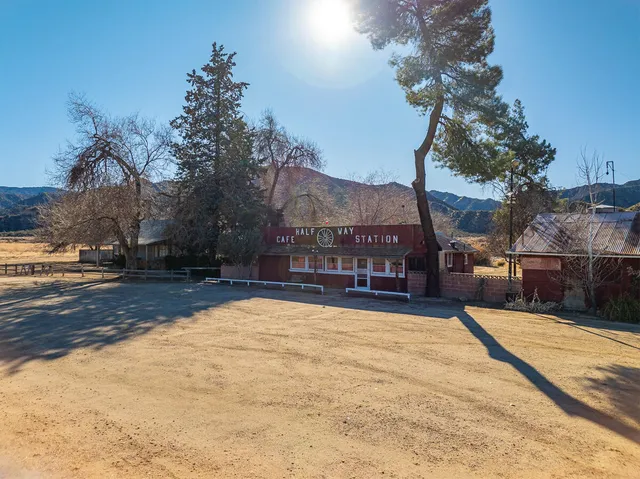 a view of a house with a yard covered in snow