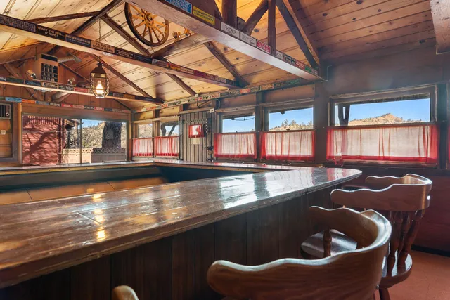 a patio with glass top table and chairs